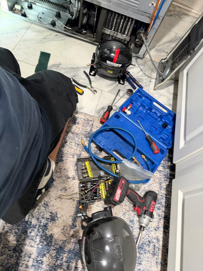 Manifold gauges on an LG refrigerator during refrigerant recovery and recharge