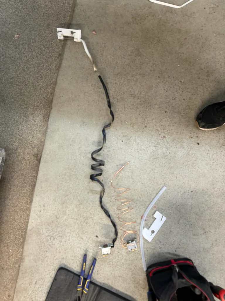 Parts removed from a Hoshizaki ice machine laid on the floor