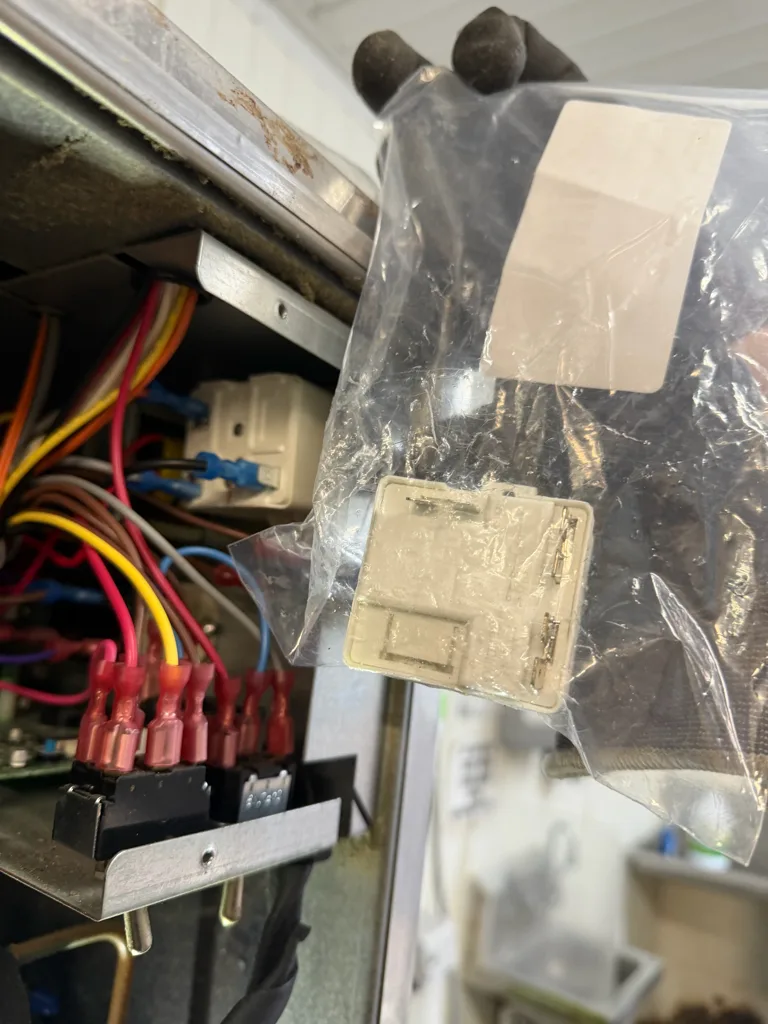 Replacement compressor start relay in a bag next to the Hoshizaki control box
