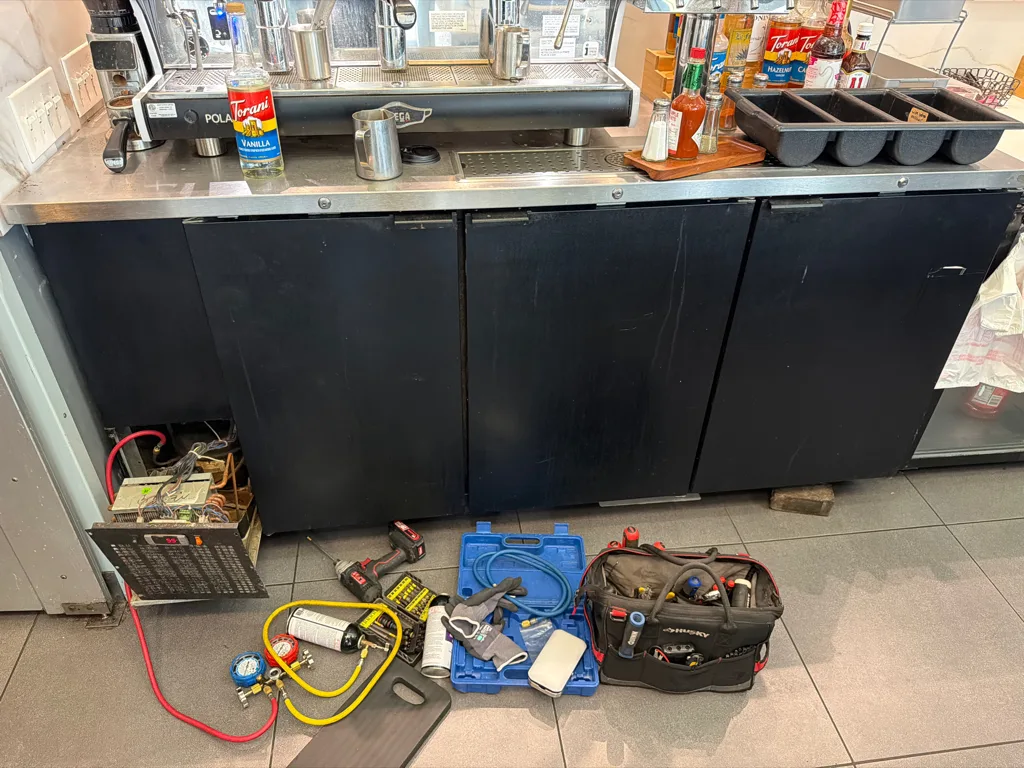 Micro Matic MDD-78 bar cooler under repair at a Tampa bar and café counter, with service tools on the floor