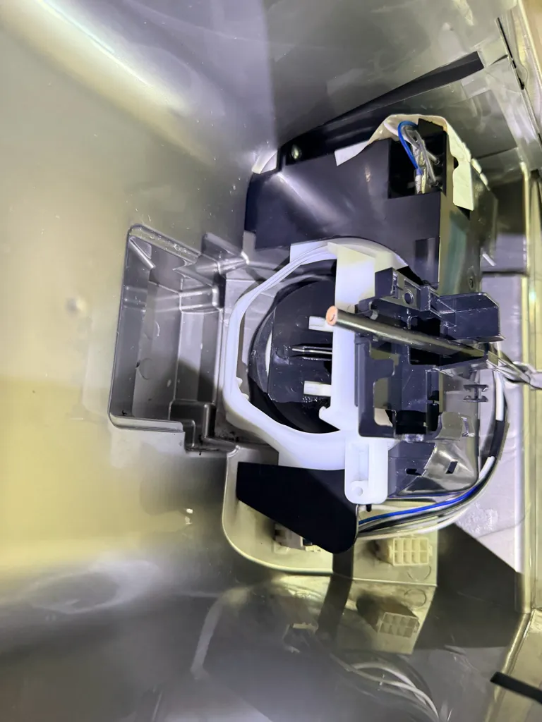 Samsung refrigerator dispenser mechanism and wiring exposed during the repair