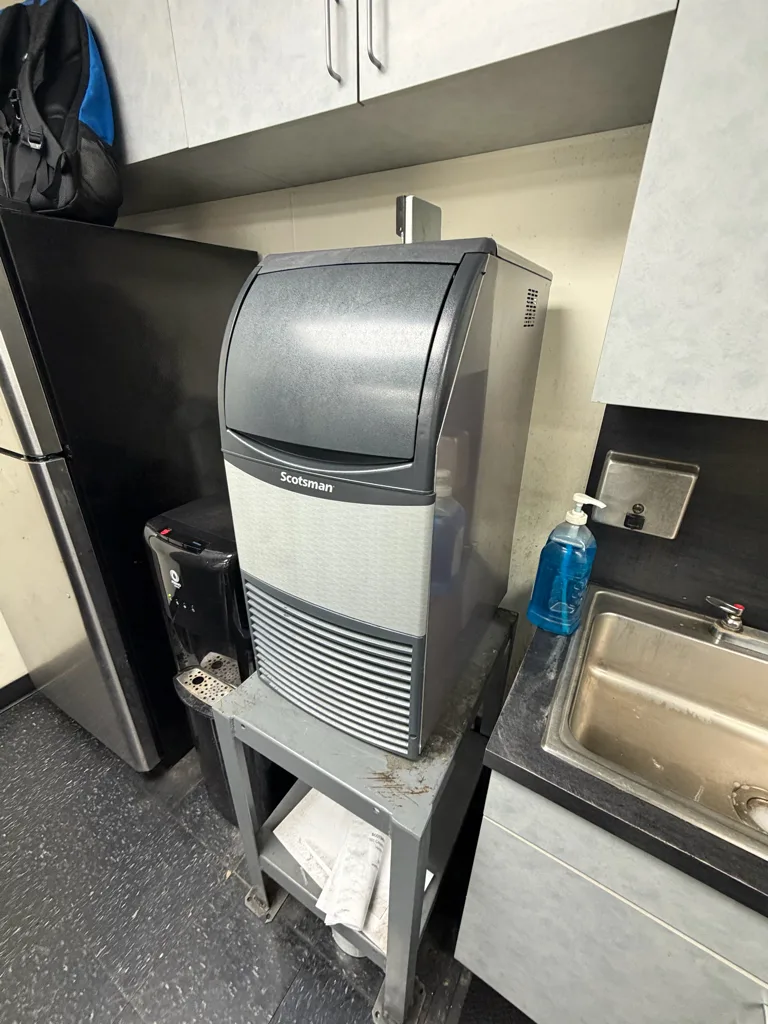 Scotsman CU0415MAX-1A commercial ice machine on a stand at a Tampa car rental company